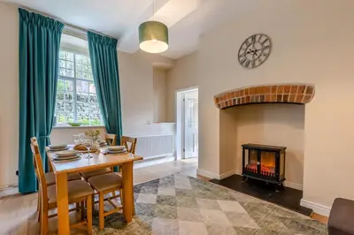 a dining room with a table and a fireplace at 2 Bed in Ludlow oc-d31885 in Ludlow