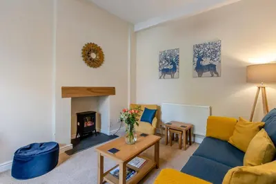 a living room with a blue couch and a fireplace at 2 Bed in Ludlow oc-d31885 in Ludlow