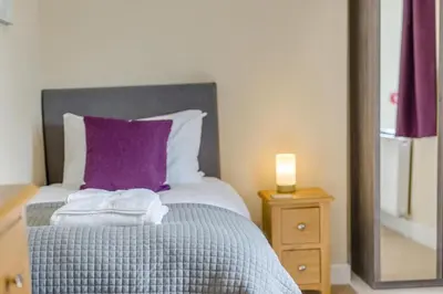 a bed with a purple pillow and a night stand at 2 Bed in Ludlow oc-d31885 in Ludlow