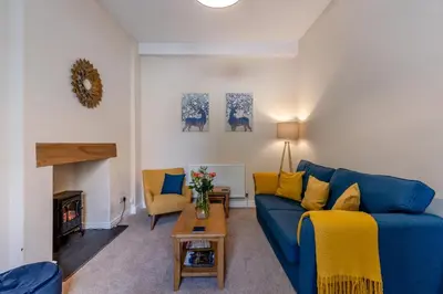 a living room with a blue couch and a fireplace at 2 Bed in Ludlow oc-d31885 in Ludlow