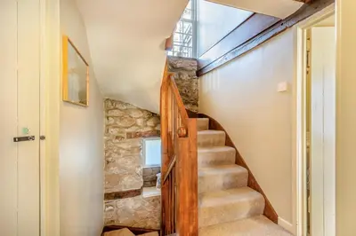 a winding staircase in a home with a stone wall at 3 Bed in Dolgellau oc-h31822 in Dolgellau