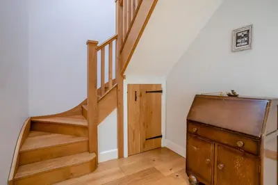 a room with a staircase and a wooden dresser at 6 Bed in Llanwern oc-w31947 in Brecon