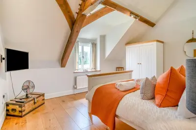 a bedroom with a bed with an orange blanket at 6 Bed in Llanwern oc-w31947 in Brecon