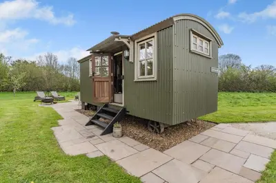 a green tiny house sitting on a patio at 1 Bed in Bronllys oc-t31949 in Bronllys