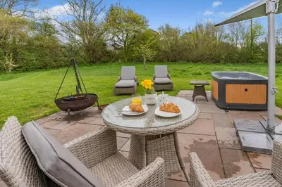 a patio with a table and chairs and a grill at 1 Bed in Bronllys oc-t31949 in Bronllys