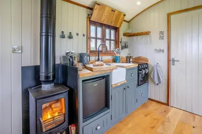 a kitchen with an oven with a fire in it at 1 Bed in Bronllys oc-t31950 in Bronllys