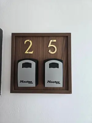 a wooden clock with two toasters on a wall at Seashell Apartment in Barmouth
