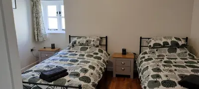 two beds sitting next to each other in a bedroom at Dog friendly rural location in Llanerch-Aeron