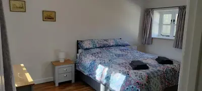 a bedroom with a bed and a window at Dog friendly rural location in Llanerch-Aeron