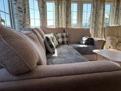a living room with a couch and a table at The Panorama View Luxury Retreat in Aberystwyth in Aberystwyth