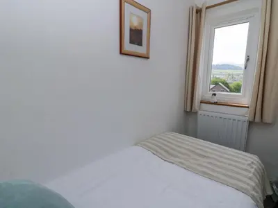 a bedroom with a bed and a window at Brycheiniog View in Brecon