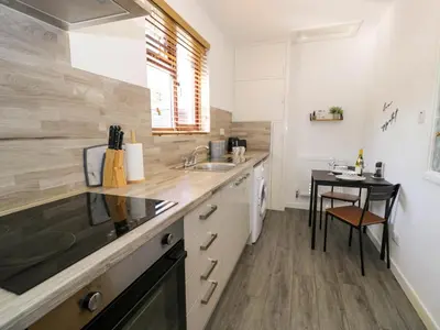 a kitchen with a sink and a table at Gilfach Bach in Dolgellau