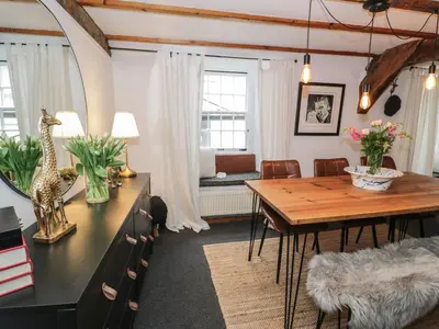 a living room with a table and a dining room at Penygrisiau in Barmouth
