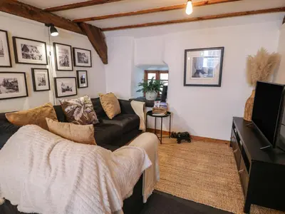 a living room with a couch and a tv at Penygrisiau in Barmouth