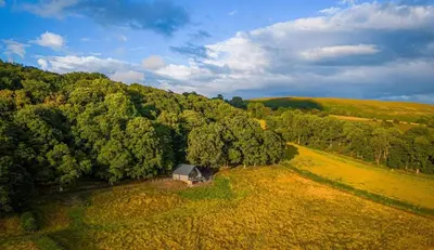 an aerial view of a barn in the middle of a forest at Oolert Treehouse in Hundred House
