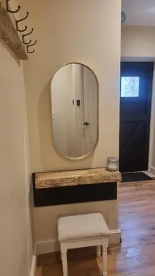 a bathroom with a mirror and a stool and a door at The Old Shop High Street in Llanidloes
