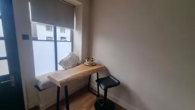 a small room with a table and a window at The Old Shop High Street in Llanidloes