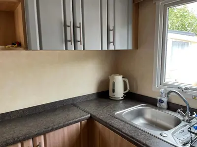 a kitchen counter with a sink and a window at Sylvan Near Hay on Wye in Rhos-gôch