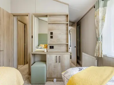a bedroom with a desk and a mirror at Hillfort Lodge in Llanrhystyd
