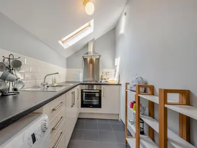 a kitchen with a sink and a stove at West Llwyn - Uk41757 in Rhyd Owen