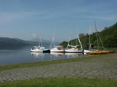 a group of boats docked in a body of water at Cysgod Bach & Caban y Saer Cottages in Bala