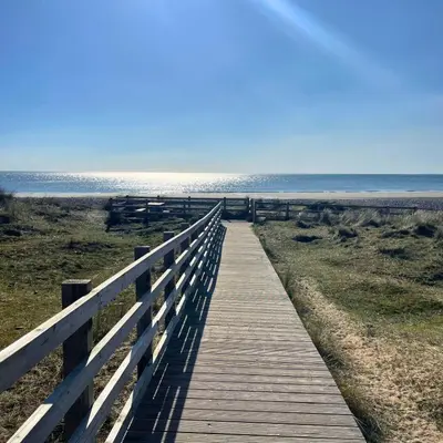 a wooden boardwalk leading to the beach at Gwyneska in Llanaber