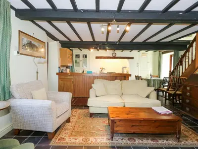 a living room with two couches and a coffee table at Cae'n Y Coed Cottage in Talsarnau