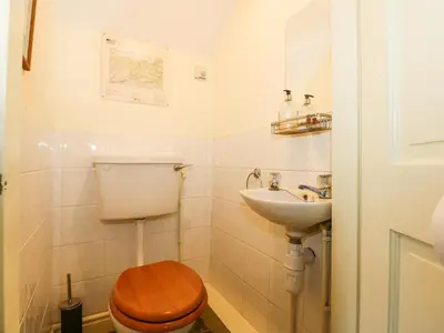 a bathroom with a toilet and a sink at Cae'n Y Coed Cottage in Talsarnau