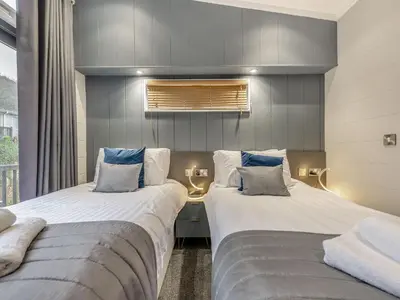 two beds sitting next to each other in a room at The Powys Lodge in New Quay