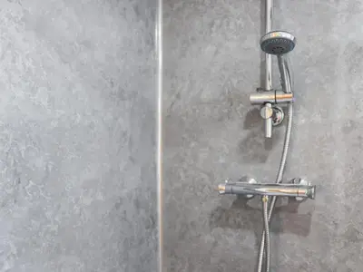 a shower with a shower head on a wall at Cae Cwta in Llanddwywe