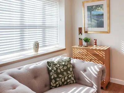 a living room with a couch and a window at Cae Cwta in Llanddwywe