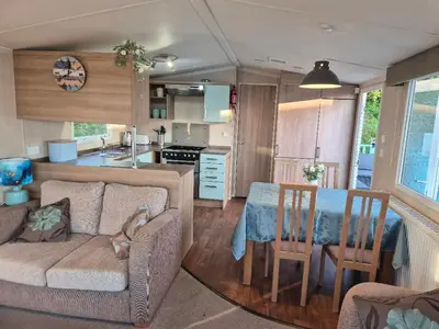a living room with a couch and a table in a kitchen at Caravan in Picturesque New Quay Wales in New Quay
