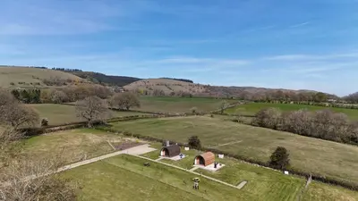 an aerial view of a house in a field at Mynd View Pods Ash in Craven Arms