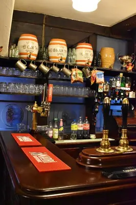 a bar in a restaurant with a counter with alcohol at Lion Royal Hotel, Rhayader in Rhayader