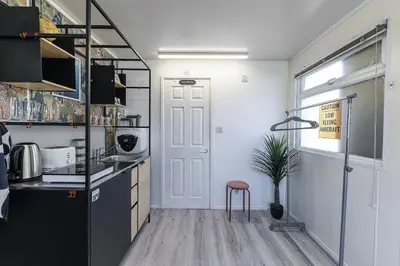 a kitchen with a counter and a stool in a room at Alaya Airways in Dolgellau