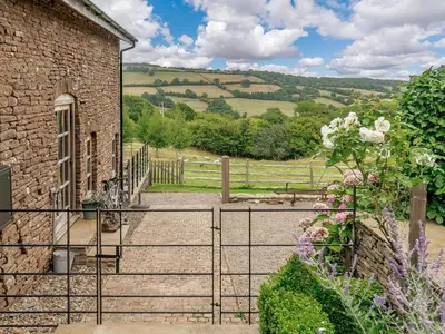 a gate to a building with a view of a field at 1 Bed in Hereford oc-42897 in Craswall