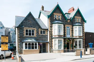 a large brick house on a city street at Maes Bach Boutique GUEST HOUSE TOWN CENTRE in Aberystwyth
