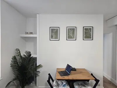 a room with a table with a laptop on it at Seasalt Apartment in Barmouth
