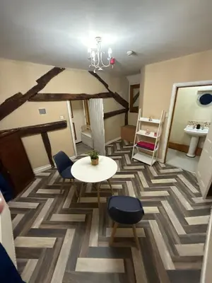a room with a table and chairs and a table and a table at Dine & Rest, 1 bedroom apartment at little India in Llanrhaeadr-ym-Mochnant