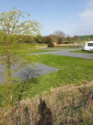 a parking lot with a van parked in a yard at Green Dragon and Kitchen Pod - Sleeps 2 & Parking in Welshpool