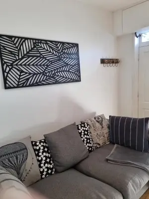 a couch with pillows on it in a living room at No 3 Waterloo Place in Welshpool