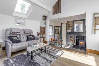 a living room with a couch and a fireplace at 1 Bed in Llwyngwril oc-a31970 in Llwyngwril