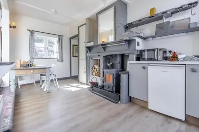 a kitchen with a stove in the middle of a room at 1 Bed in Llwyngwril oc-a31970 in Llwyngwril