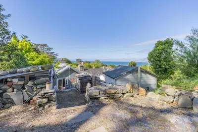 an aerial view of a house with a stone wall at 1 Bed in Llwyngwril oc-a31970 in Llwyngwril