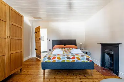 a bedroom with a bed and a fireplace at 4 bedroom farmhouse Brecon Beacons in Talgarth