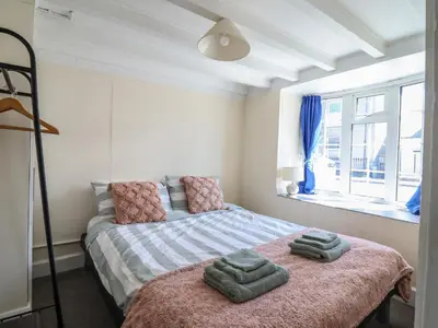 a bedroom with a bed with two towels on it at Glan Y Mor Borth in Aberystwyth