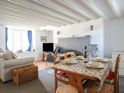 a living room with a table and a couch at Glan Y Mor Borth in Aberystwyth