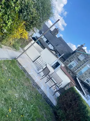 a group of chairs sitting on the side of a house at Llwyn Celyn 2 bedroom in Bala