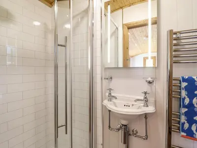 a bathroom with a sink and a shower at Celyn in Dolgellau