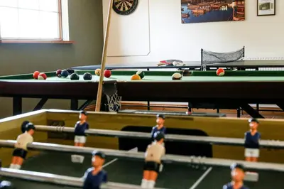a group of children playing a game of pool at Y Dderwen Aberaeron in Llanarth